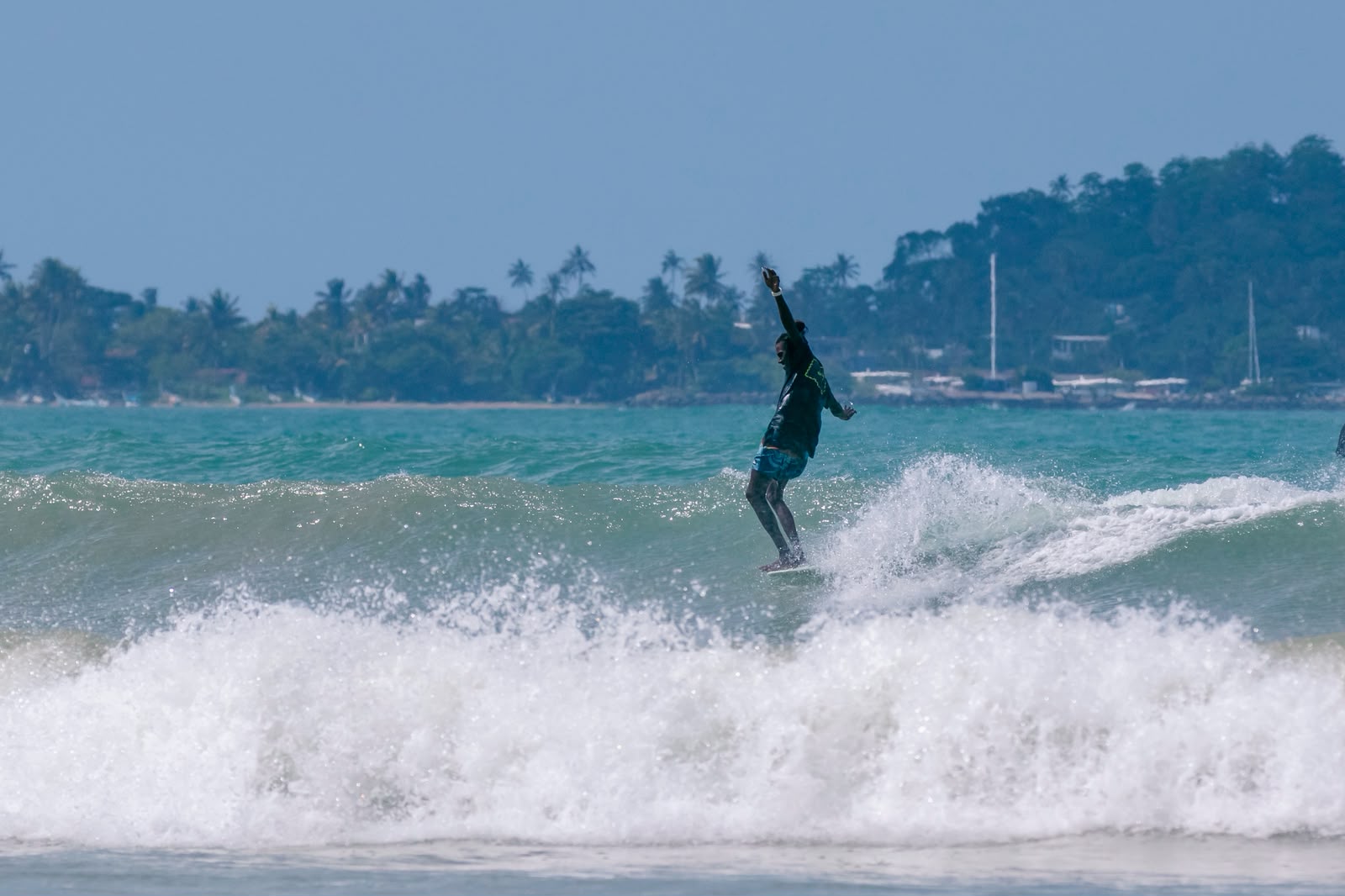 Achi surfing a wave on Sri Lanka's south coast